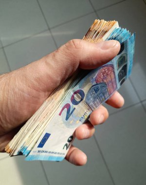 20 euro banknotes in the hands of a wealthy person clipart