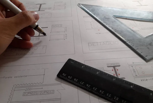 Engineer Designing a new freehand structure with his pencil