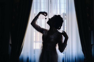 Yemeden önce elinde kiraz tutan bir kadının silüeti..