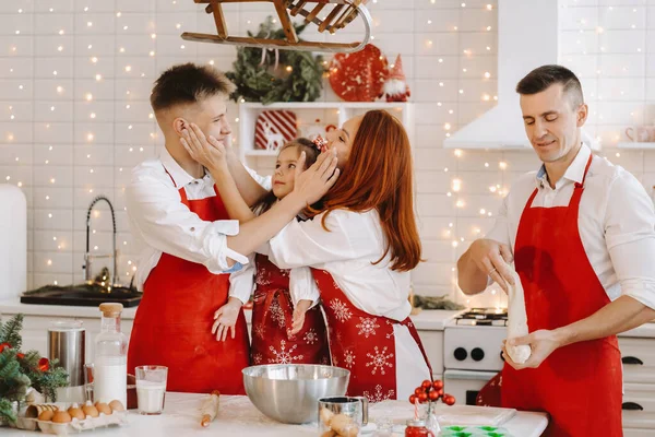 一个快乐的家庭正站在圣诞节的厨房里 用面粉擦拭彼此 — 图库照片