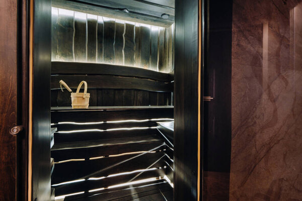 Bucket and ladle in a wooden sauna. Wooden accessories in the sauna.