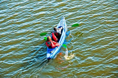 Gençler Dinyeper Nehri 'nde kano sporu yapıyor. Suyun sonbahar sarısı tonları. Spor. Sağlıklı yaşam tarzı kavramı.