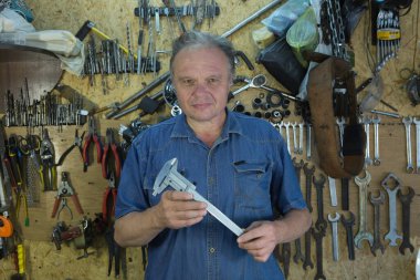 Working with a caliper. Master's hands at work. Home workshop