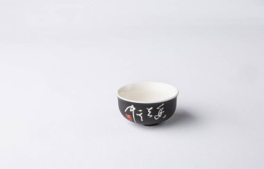 Traditional cup for oriental tea drinking on a white background, copy space. Traditional Asian ceramic cup.
