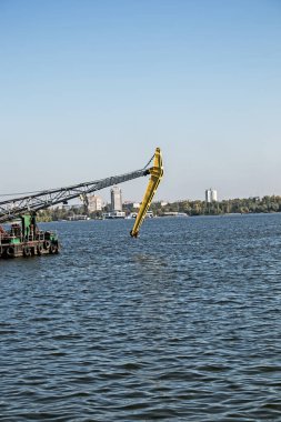 Dredger nehirde. Nehrin dibini temizliyorum. Nehir akışını muhafaza et. Doğa, nehir, gökyüzü, bulutlar.