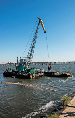 Yeni kurulan adayı Dnieper Nehri 'ndeki endüstriyel atıklardan temizliyorum. Modern nehirlerin çevresel sorunları. Ekoloji kavramı.
