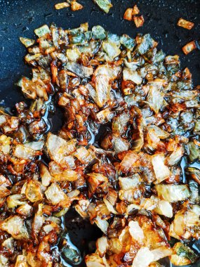 Soğanlar tavada sebze yağında kızartılır. Yakın plan..