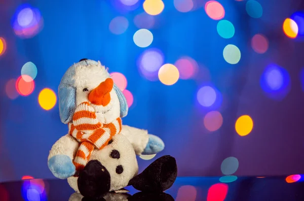 Happy snowman toy sparkling and fabulous bokeh background with copy space. Christmas background for postcards. Christmas decoration concept.