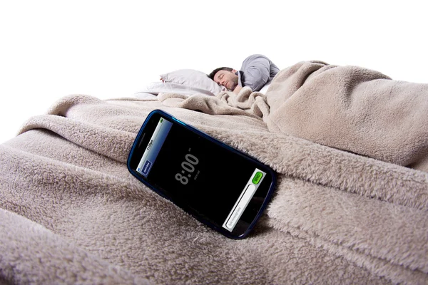 Hombre en la cama con reloj despertador — Foto de Stock