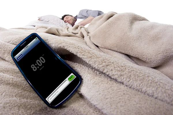 Homem na cama com relógio de alarme — Fotografia de Stock