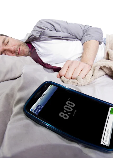 Hombre en la cama con reloj despertador — Foto de Stock