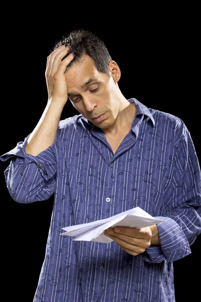 Stressed man reading bills — Stock Photo, Image