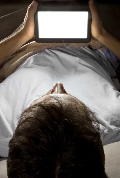 Ember az ágyban egy tabletta — Stock Fotó
