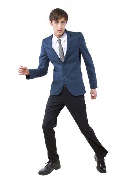 Businessman held back by imaginary obstacle pulling on leg — Stock Photo, Image