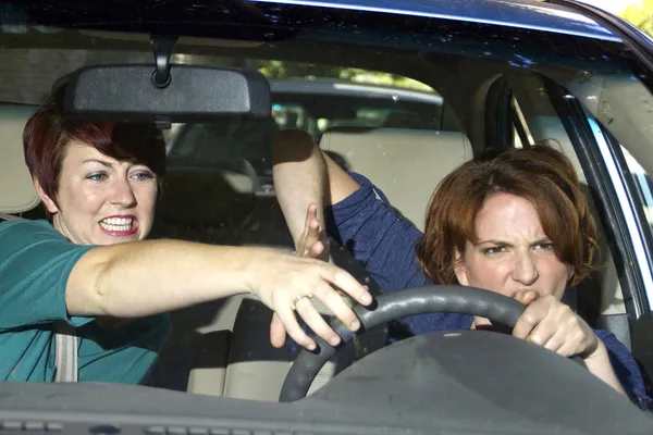 Annoying passenger by being a "backseat driver" — Stock Photo, Image