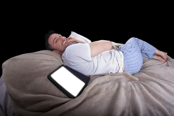 Male reading on a tablet before going to sleep — Stock Photo, Image