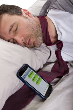Man sleeping and receiving text messages from work clipart