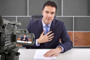 Camera recording male reporter