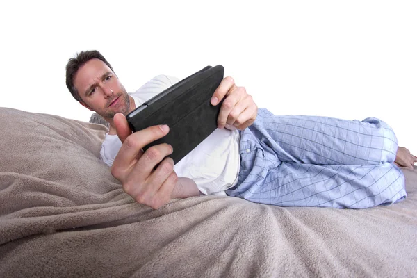 Lectura masculina en una tableta antes de ir a dormir —  Fotos de Stock