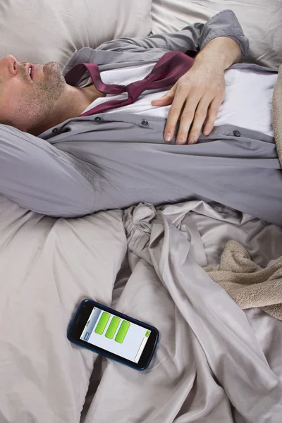 L'uomo dorme e ricezione di messaggi di testo dal lavoro — Stockfoto