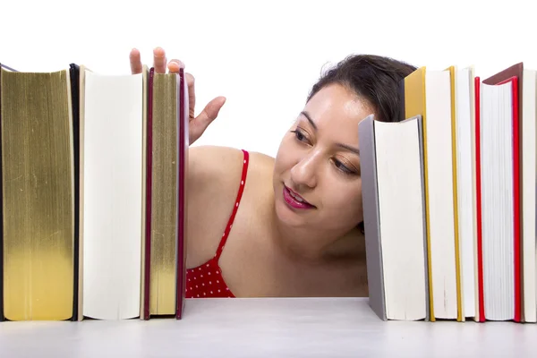 Woman reading books from bookshelf — Stock Photo, Image
