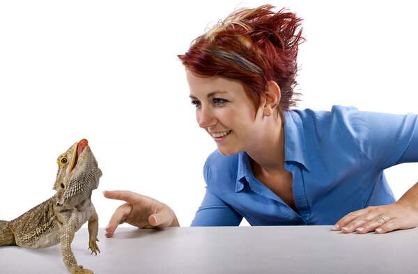 Girl staring at spikey bearded dragon reptile