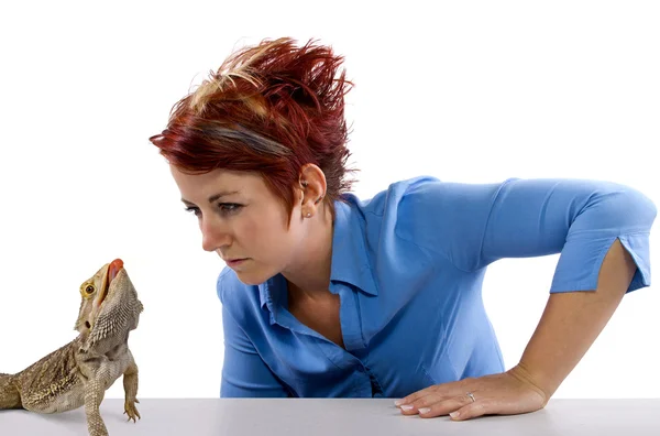 Girl staring at spikey bearded dragon reptile — Stock Photo, Image