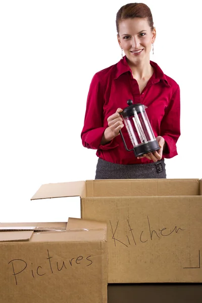 Woman packing stuff in moving boxes — Stock Photo, Image