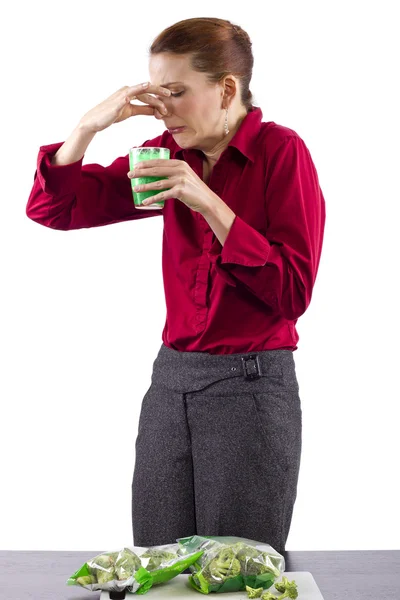 Woman grossed out by vegetable juice — Stock Photo, Image