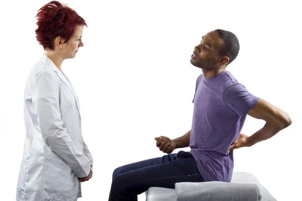 Therapist consulting male about posture — Stock Photo, Image