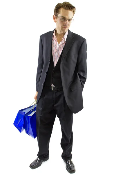 Männchen posiert mit Einkaufstaschen — Stockfoto