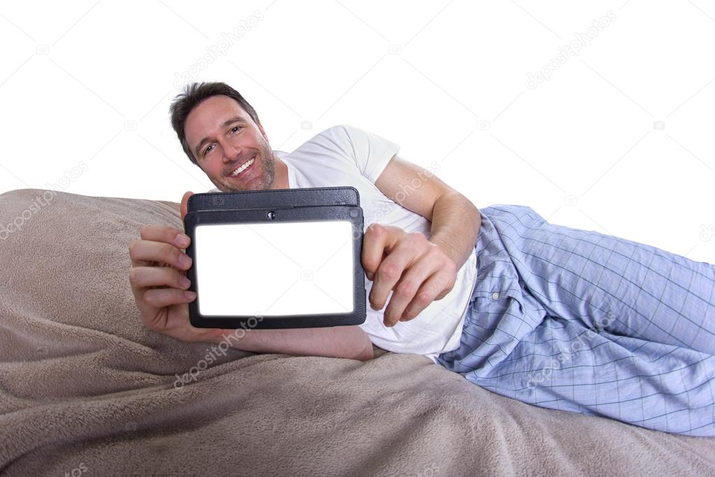 Male reading on a tablet before going to sleep