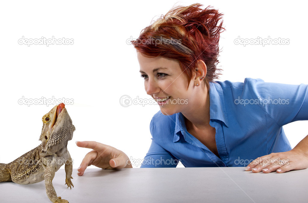 Girl staring at spikey bearded dragon reptile