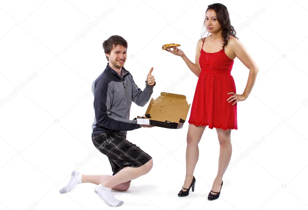 Delivery boy offering pizza to girl