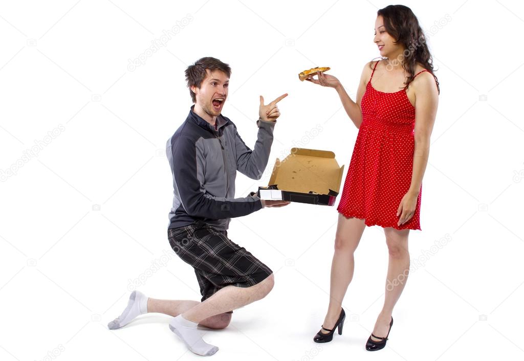 Delivery boy offering pizza to girl