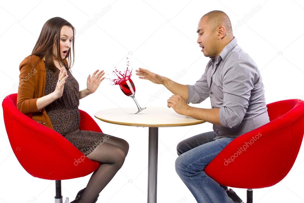 Man spilling drink on girlfriend