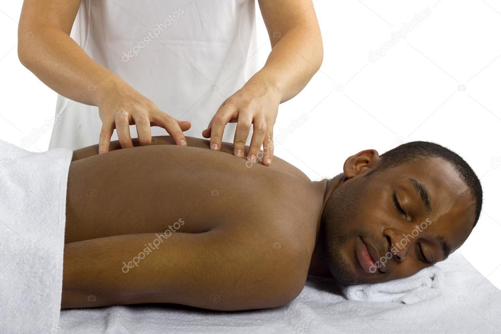 Therapist examining male spinal column