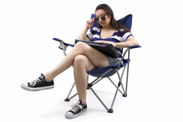 Woman with laptop sitting on chair — Stock Photo, Image