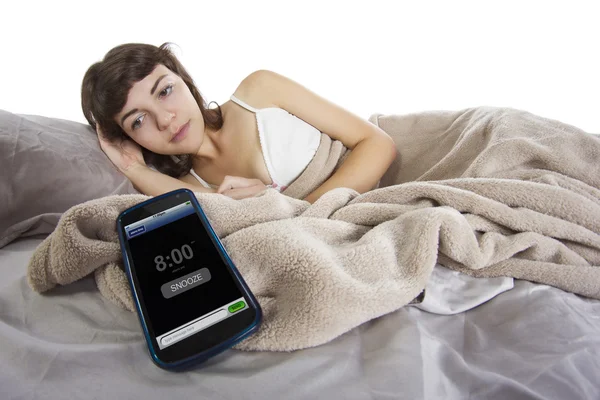 Female snoozing modern cell phone alarm clock — Stock Photo, Image
