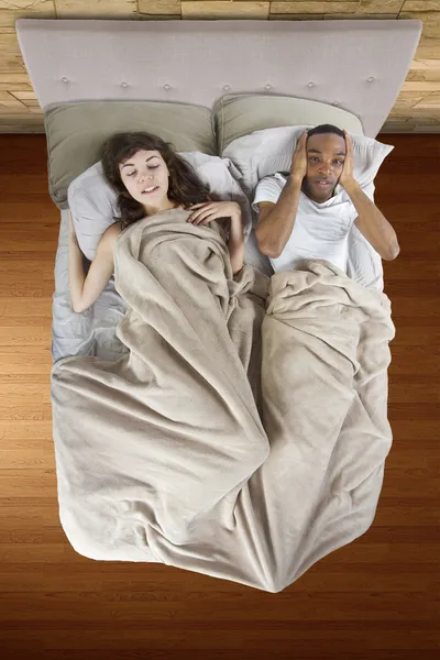 Unable to sleep in bed because of snoring partner — Stock Photo, Image
