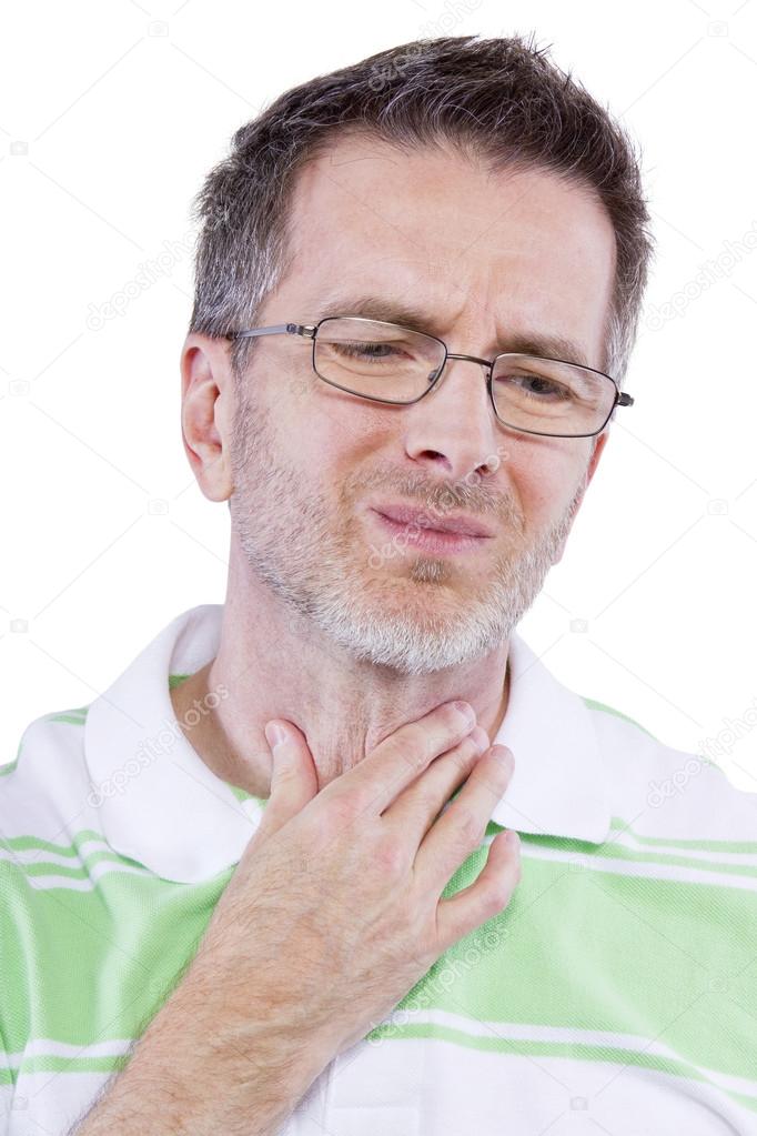 Male holding painful throat and frowning