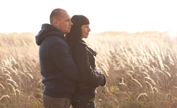 Young couple in the autumn on the nature