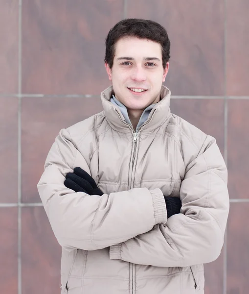 Guy in a jacket standing in winter — Stock Photo, Image