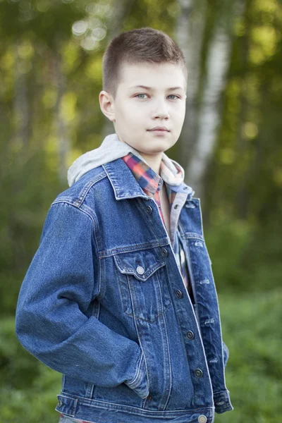 Young boy standing in the park — Stock Photo, Image