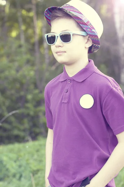 Boy in a cap and glasses outdoors — Stock Photo, Image