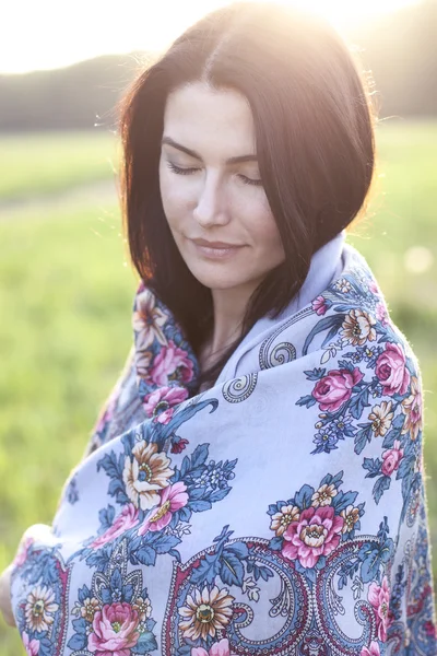 Girl in a scarf dreaming outdoors — Stock Photo, Image