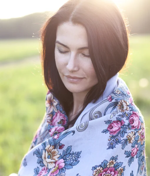 Girl in a scarf dreaming outdoors — Stock Photo, Image