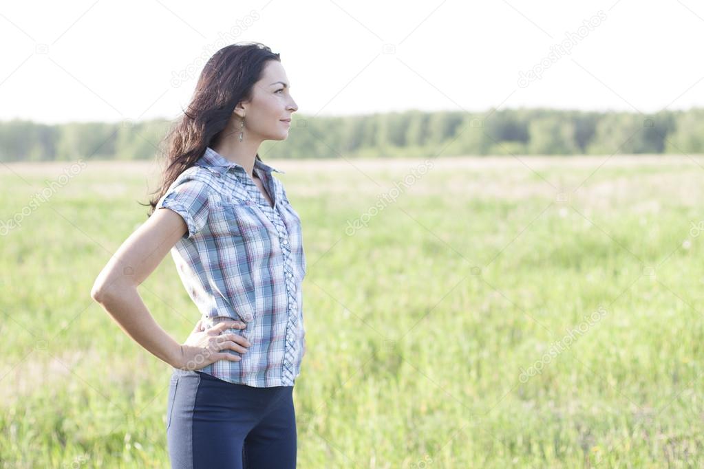 Woman  looks into the distance outdoors
