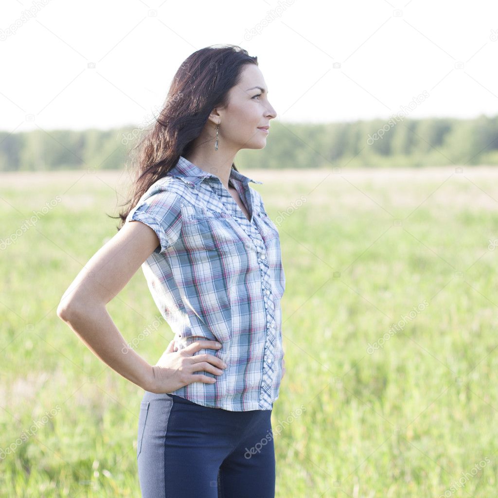 Woman  looks into the distance outdoors