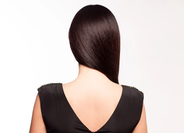 Brunette black dress stands — Stock Photo, Image